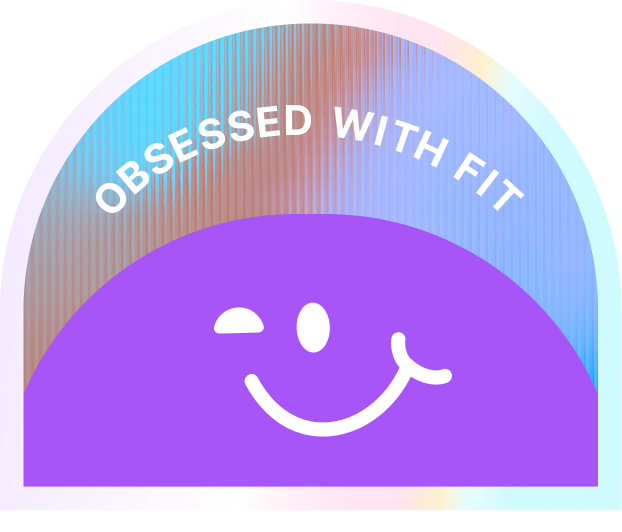 Holographic half-circle badge with purple bottom featuring a winking smiley face and white text above reading 'OBSESSED WITH FIT'.